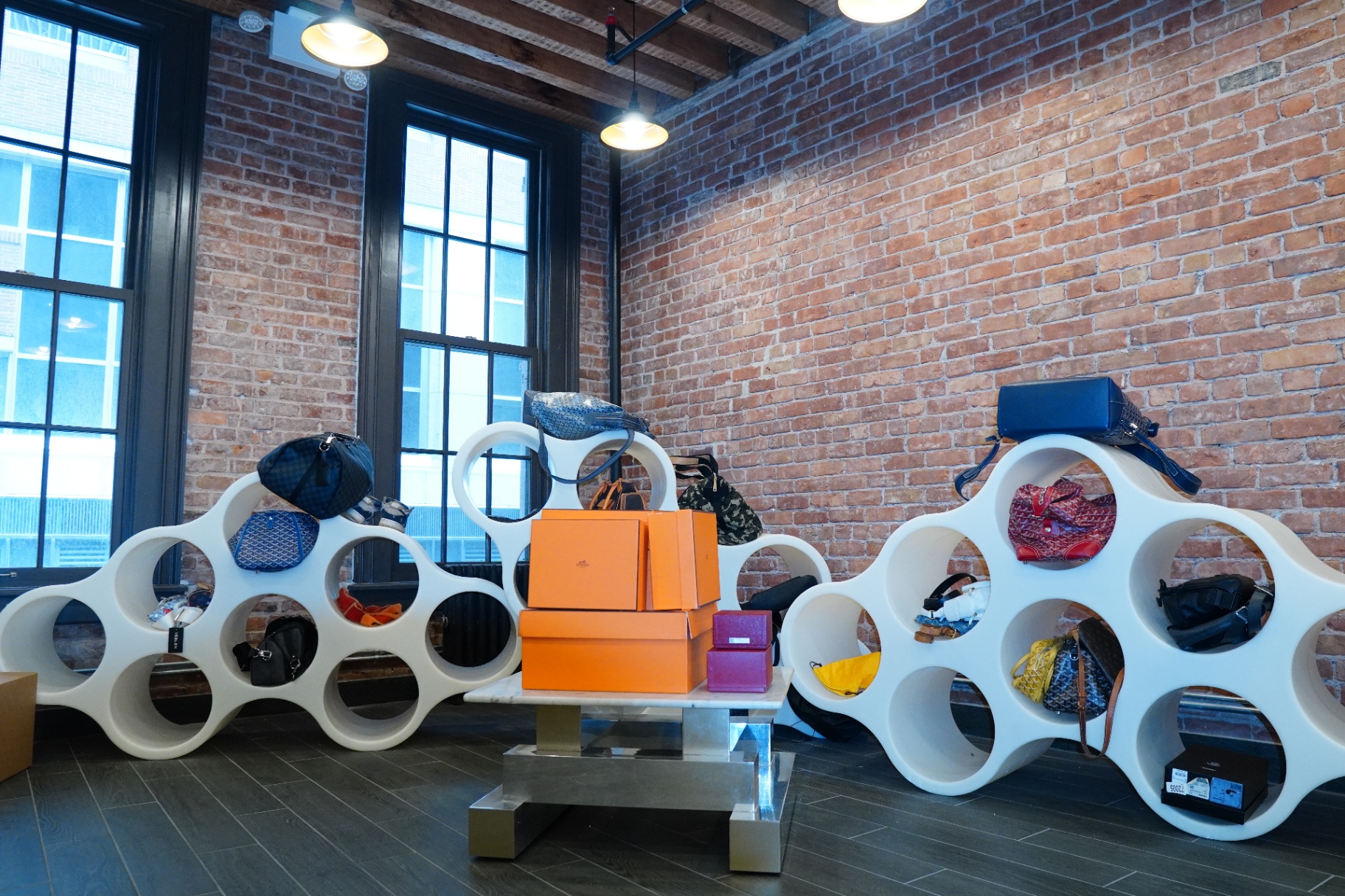 Designer handbag display on sculptural shelving at the Once Legos NYC showroom